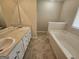 Bright bathroom featuring a double sink vanity and a large soaking tub at 1222 Snapping Shoals Rd, Mcdonough, GA 30252