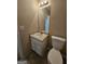 A simple bathroom with a small sink and vanity at 1222 Snapping Shoals Rd, Mcdonough, GA 30252