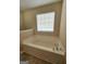 Bathroom showcasing a bright soaking tub and window at 1222 Snapping Shoals Rd, Mcdonough, GA 30252