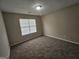 A standard empty bedroom with carpet flooring and a window at 1222 Snapping Shoals Rd, Mcdonough, GA 30252
