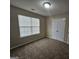 A standard empty bedroom with carpet flooring and a window at 1222 Snapping Shoals Rd, Mcdonough, GA 30252