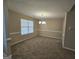 Spacious dining room features a modern chandelier, a large window, and neutral walls at 1222 Snapping Shoals Rd, Mcdonough, GA 30252