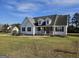 Inviting home with a covered front porch, manicured lawn, and a classic architectural design at 1222 Snapping Shoals Rd, Mcdonough, GA 30252