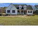 Beautiful house with white siding, black shutters, dormer windows, and a cozy front porch at 1222 Snapping Shoals Rd, Mcdonough, GA 30252