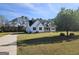 Charming white home with a welcoming front porch, green lawn, and a long driveway leading to the house at 1222 Snapping Shoals Rd, Mcdonough, GA 30252