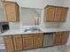 Kitchen showing the stainless steel sink, dishwasher, and view to the fireplace at 1222 Snapping Shoals Rd, Mcdonough, GA 30252