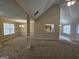 Open concept living room with tall ceilings and a partial view of the kitchen at 1222 Snapping Shoals Rd, Mcdonough, GA 30252