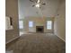 Bright living room with a stone fireplace, plush carpet, and large windows that let in plenty of natural light at 1222 Snapping Shoals Rd, Mcdonough, GA 30252