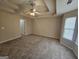 Spacious main bedroom featuring tray ceilings and a view to the backyard at 1222 Snapping Shoals Rd, Mcdonough, GA 30252