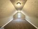 Finished attic with carpet, white trim, and a window at 596 Carlton Rd, Palmetto, GA 30268
