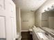 Bright bathroom with wood-look floors, granite vanity, and bathtub-shower combo at 596 Carlton Rd, Palmetto, GA 30268