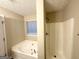 Bright bathroom featuring a soaking tub and a separate shower with neutral wall paint at 596 Carlton Rd, Palmetto, GA 30268
