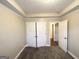 Bedroom with neutral paint, carpeted floors, and a large closet with folding doors at 596 Carlton Rd, Palmetto, GA 30268