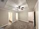 Relaxing bedroom with trey ceiling, ceiling fan, carpeted floors, and ensuite bathroom access at 596 Carlton Rd, Palmetto, GA 30268