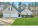 Charming single Gathering home featuring manicured lawn, two car garage, and stone facade at 596 Carlton Rd, Palmetto, GA 30268