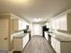 Well-lit kitchen featuring granite countertops, white cabinetry, and modern appliances at 596 Carlton Rd, Palmetto, GA 30268