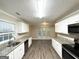 Spacious kitchen with granite countertops, stainless steel appliances, and bright white cabinetry at 596 Carlton Rd, Palmetto, GA 30268