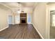Bright living room featuring a cozy brick fireplace, wood flooring, and a ceiling fan at 596 Carlton Rd, Palmetto, GA 30268