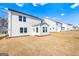 The back of the house features bright white siding and multiple windows with a large, grassy yard at 1619 Tide Mill Rd, Cumming, GA 30040