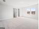 Carpeted bedroom with view to walk-in closet, neutral walls, and bright windows at 1619 Tide Mill Rd, Cumming, GA 30040