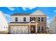 Inviting two-story brick home featuring an attached garage and a covered entryway at 1619 Tide Mill Rd, Cumming, GA 30040