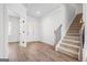 Bright foyer features wood-look floors, a staircase, and an entry to the office space at 1619 Tide Mill Rd, Cumming, GA 30040