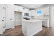 Modern kitchen features white cabinets, stainless steel appliances, and a center island at 1619 Tide Mill Rd, Cumming, GA 30040