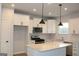 Modern kitchen features recessed lighting, white cabinets, and a center island at 1619 Tide Mill Rd, Cumming, GA 30040