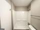 Bathroom features a shower and tub combination with white tile surround at 6635 Hidden Brook Trl, South Fulton, GA 30349