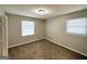 Bright bedroom with plush carpeting and natural light from two windows at 6635 Hidden Brook Trl, South Fulton, GA 30349