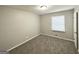 Cozy bedroom with neutral paint and a window offering natural light at 6635 Hidden Brook Trl, South Fulton, GA 30349