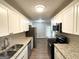 Updated kitchen with stainless steel appliances and granite countertops at 6635 Hidden Brook Trl, South Fulton, GA 30349