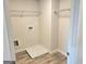 Bright laundry room with tile floors, wire shelves, and washer/dryer hookups at 4841 Walkers Green, Mableton, GA 30126