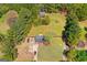 Aerial view of property featuring mature trees, green grass and long driveway at 2079 Leguin Mill Rd, Locust Grove, GA 30248
