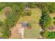 Aerial view of property showcasing the house, outbuilding, expansive yard and surrounding greenery at 2079 Leguin Mill Rd, Locust Grove, GA 30248