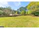 Expansive backyard offering ample space, a patio, and a glimpse of the home's exterior at 2079 Leguin Mill Rd, Locust Grove, GA 30248