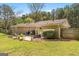 Spacious backyard with a patio area, outdoor furniture, and a well-maintained lawn at 2079 Leguin Mill Rd, Locust Grove, GA 30248