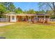 Charming single-story brick home featuring a welcoming front porch and well-maintained lawn at 2079 Leguin Mill Rd, Locust Grove, GA 30248