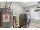 Laundry room featuring washer and dryer, built in storage and water heater at 2079 Leguin Mill Rd, Locust Grove, GA 30248