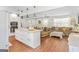 Open concept living space with a modern kitchen, dining area, and comfortable living area with wood floors at 2079 Leguin Mill Rd, Locust Grove, GA 30248