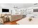 Bright, open-concept living space with a cozy seating area, dining table, and a view into the modern kitchen at 2079 Leguin Mill Rd, Locust Grove, GA 30248