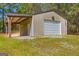 Large outbuilding featuring a roll-up garage door and covered parking area, offering storage and utility at 2079 Leguin Mill Rd, Locust Grove, GA 30248