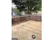 Spacious wood backyard deck with stained wood railing at 3221 Rock Creek Dr, Rex, GA 30273