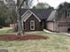 Charming two-story home featuring brick accents, an attached garage, and a well-maintained lawn at 3221 Rock Creek Dr, Rex, GA 30273