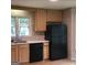 Kitchen featuring black appliances, wood floors, and light wood cabinetry at 3221 Rock Creek Dr, Rex, GA 30273