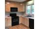 Well-lit kitchen featuring black appliances, light wood cabinets, and a dual stainless steel sink at 3221 Rock Creek Dr, Rex, GA 30273