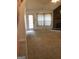 Spacious living room featuring a brick fireplace and access to the backyard at 3221 Rock Creek Dr, Rex, GA 30273