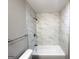 This bathroom has a white tub with tiled walls, a shower head, and a towel rack at 120 Gran De, Atlanta, GA 30349