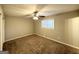 This carpeted bedroom features a ceiling fan and a window for natural light at 120 Gran De, Atlanta, GA 30349