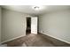 Bedroom has carpet, gray walls, white trim, closet, and a view of the stairway at 120 Gran De, Atlanta, GA 30349
